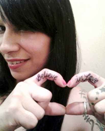 Believe In Love Black Ink Finger Tattoo For Smiling Girl