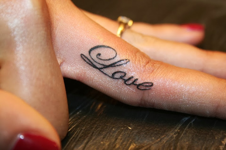 Charming Black Ink Love Tattoo On Women Index Finger