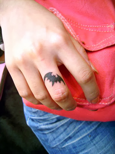 Cool Small Black Ink Bat Tattoo On Men Middle Finger