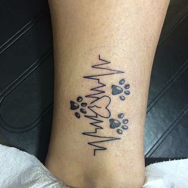 Fantastic Black Ink Lion Paw And Heartbeat Tattoo Design Made On Women Leg