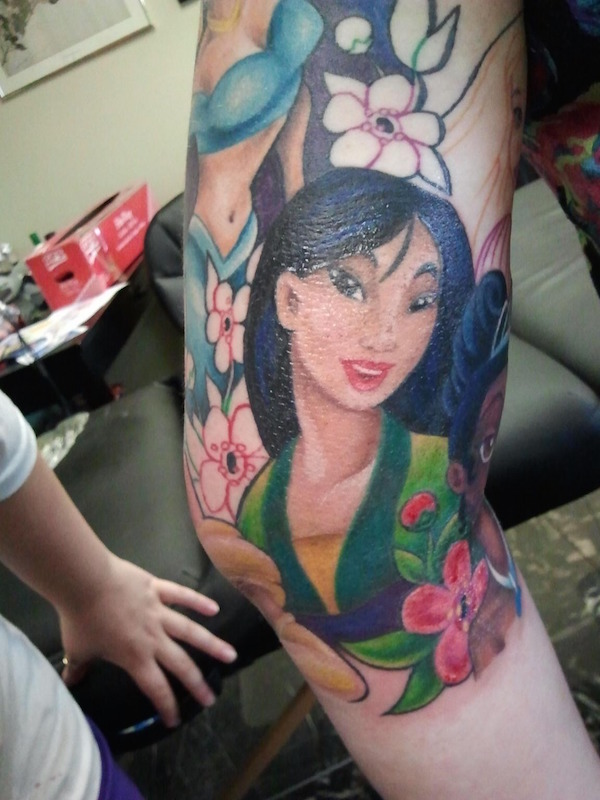 Lovely Colorful Animated Asian Girl Face Tattoo On Men Sleeve