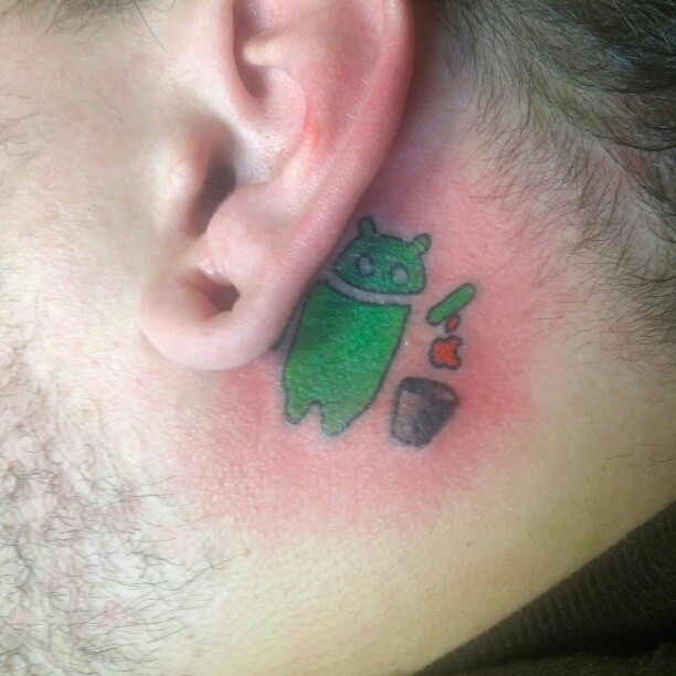 Outstanding Small Android Apple Tattoo Design On Men Back Ear