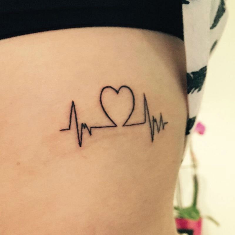 Simple Black Ink Heart EKG Heartbeat Tattoo For Girl Ribs Side