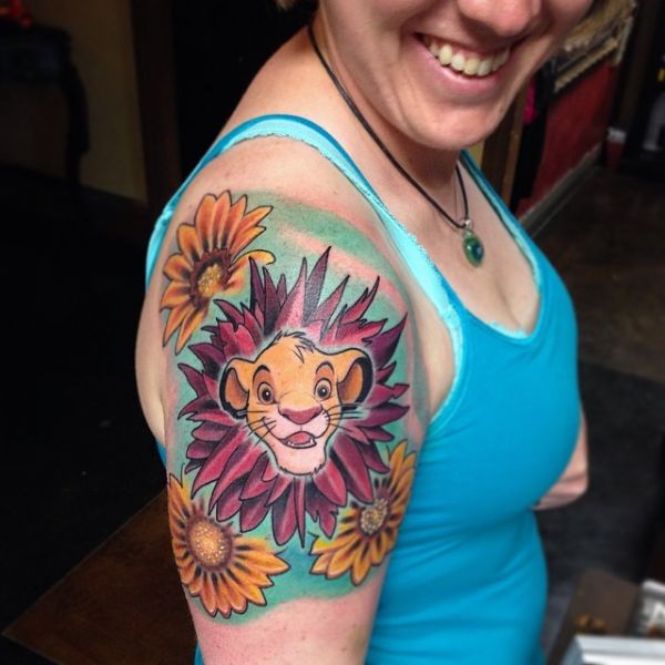 Women With Amazing Colorful Ink Animated Simba Lion Flower Tattoo On Shoulder