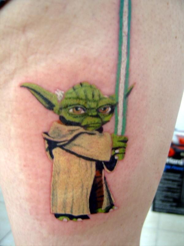 Wonderful Green Ink Animated Yoda With Sword Tattoo On Thigh